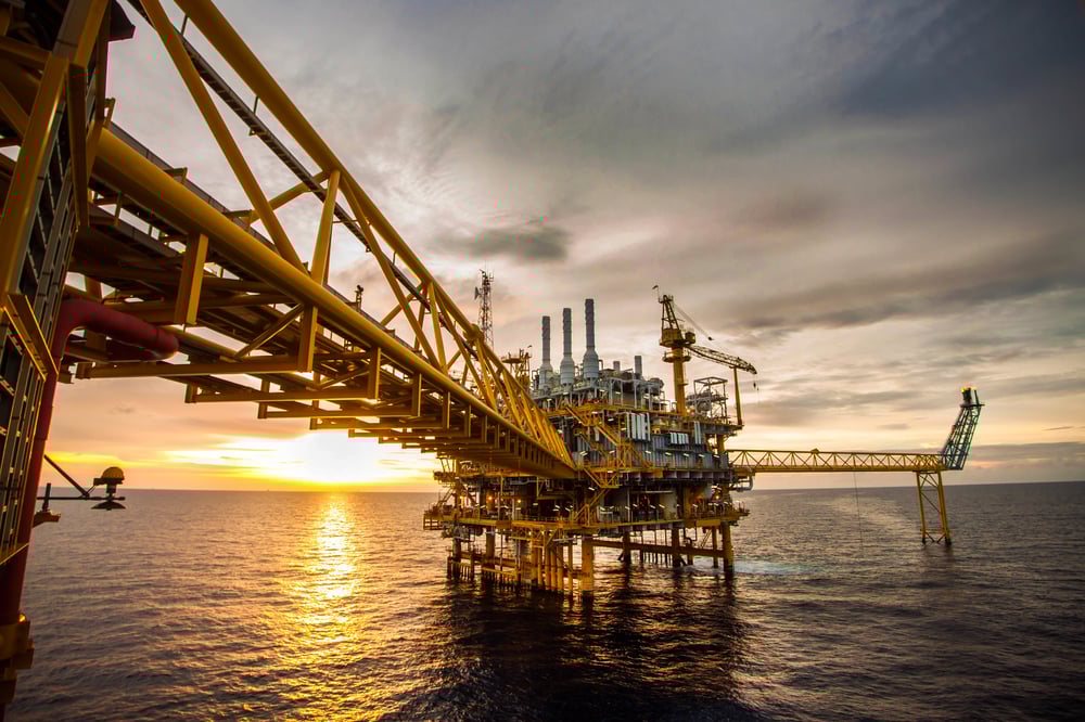 Offshore oil platform at sunset used for drilling and well monitoring operations. Offshore oil platform at sunset used for drilling and well monitoring operations.